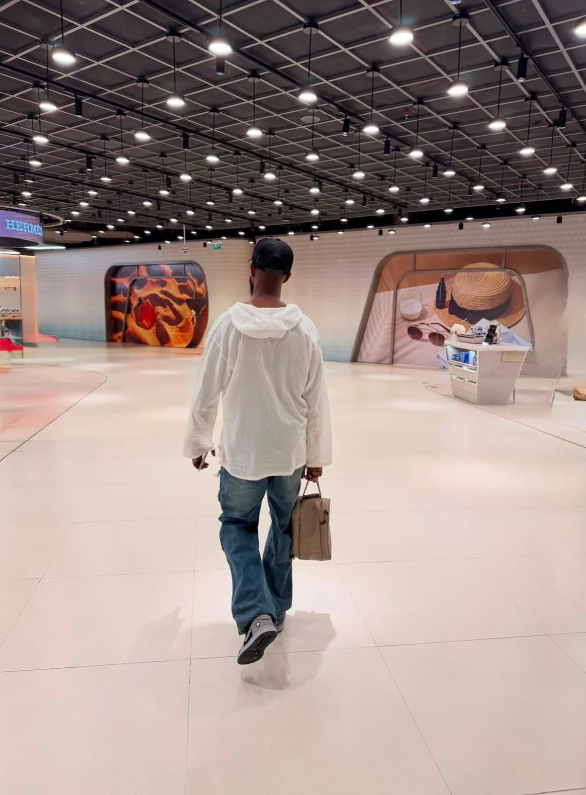 Ahmed walking through a Dubai mall concourse